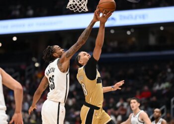 Brooklyn Nets center Nic Claxton (33) blocks a shot by Washington Wizards forward Kyshawn George (18).