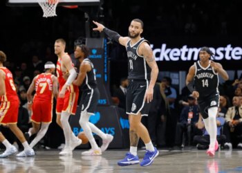 Tyrese Martin #13 of the Brooklyn Nets points on the court during the second half of a game against the Atlanta Hawks.