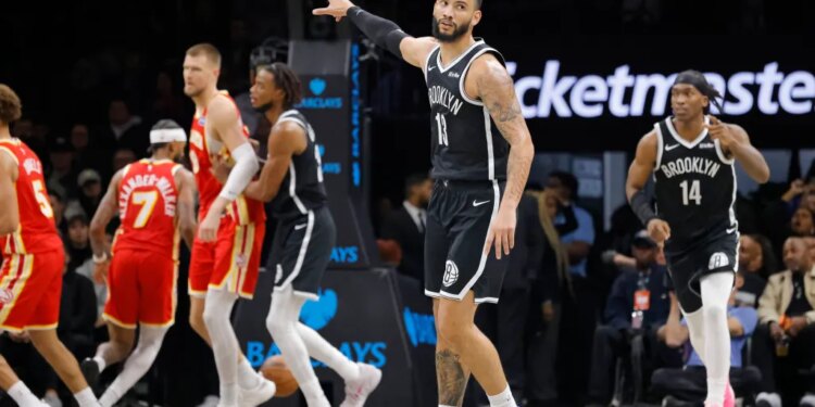 Tyrese Martin #13 of the Brooklyn Nets points on the court during the second half of a game against the Atlanta Hawks.