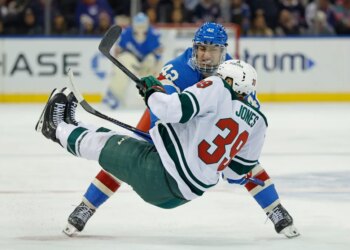 Noah Laba checks Minnesota Wild center Ben Jones to the ice in the third period at Madison Square Garden in New York, October 20, 2025.