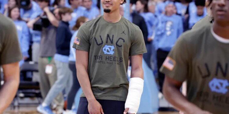 North Carolina guard Seth Trimble, with a cast on his arm, watches his teammate warm up before an NCAA college basketball game against Radford.