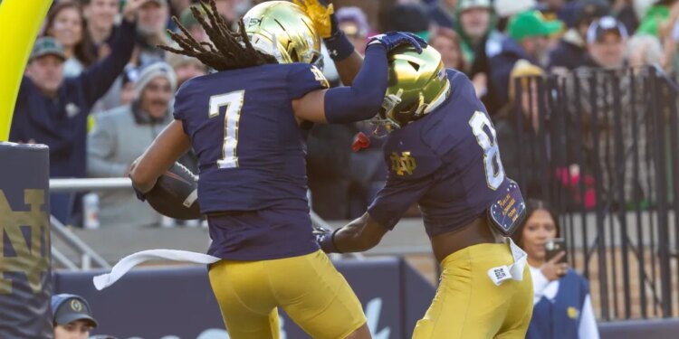 Notre Dame Fighting Irish safety Jalen Stroman (7) celebrates scoring on an interception with Notre Dame Fighting Irish safety Adon Shuler (8) against the Syracuse Orange during the first half at Notre Dame Stadium