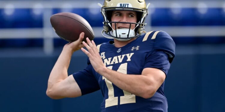 Navy Midshipmen quarterback Blake Horvath (11) throwing a football.