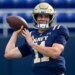 Navy Midshipmen quarterback Blake Horvath (11) throwing a football.