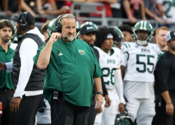 Ohio Bobcats head coach Brian Smith on the sideline during a football game.