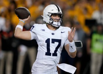 Penn State quarterback Ethan Grunkemeyer throwing a pass during a college football game against Iowa.