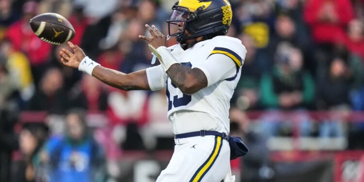 Michigan quarterback Bryce Underwood (19) throws against Maryland during the first half of an NCAA college football game, Saturday, Nov. 22, 2025, in College Park, Md. (AP Photo/Stephanie Scarbrough)