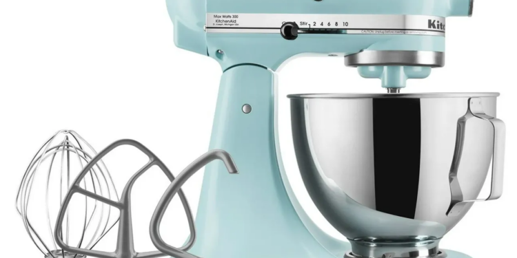 Blue mixer with three attachments next to it.