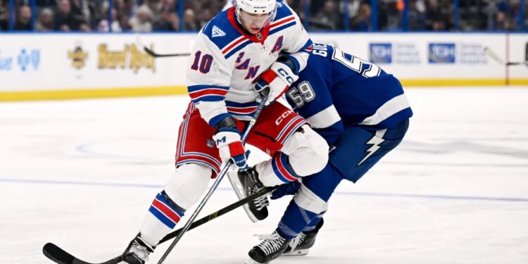 Artemi Panarin battles Jake Guentzel for the puck during the Rangers' 7-3 blowout road win over the Lightning on Nov. 12, 2025.