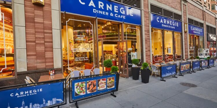 Exterior of Carnegie Diner & Cafe, a New York City restaurant, with outdoor seating on the sidewalk.