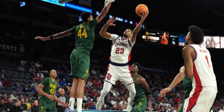 St. John's Red Storm forward Bryce Hopkins (23) goes for a layup against Baylor Bears center Caden Powell (44) in a 2025 Players Era Festival group play game at Michelob Ultra Arena.