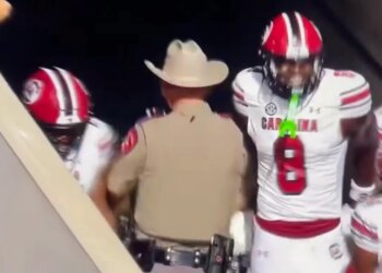 The Texas trooper stepping between two South Carolina players after scoring a touchdown.
