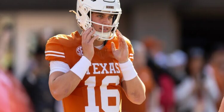 Texas Longhorns football player Quinn Ewers in his white helmet with a longhorn logo and orange jersey with number 16.