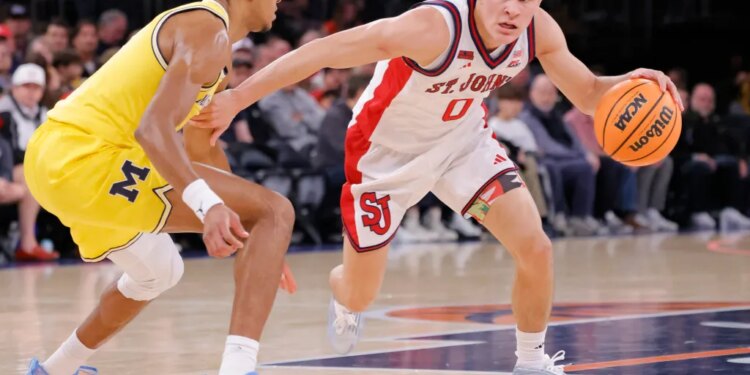 St. John's Red Storm guard Dylan Darling (0) drives around the outside during the first half when the St. John's Red Storm played the Michigan Wolverines Saturday, October 25, 2025 at Madison Square Garden in Manhattan, NY.