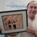 Victor Conte holds up an autographed photo addressed to Conte of track star Marion Jones in his office in Burlingame, Calif., Oct. 21, 2003.