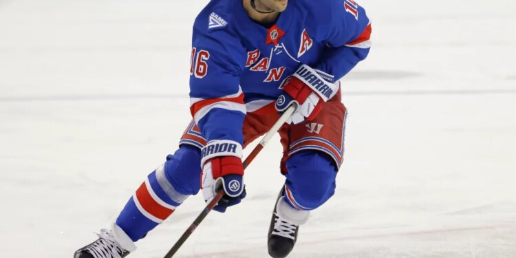 New York Rangers center Vincent Trocheck (16) moves the puck down ice.