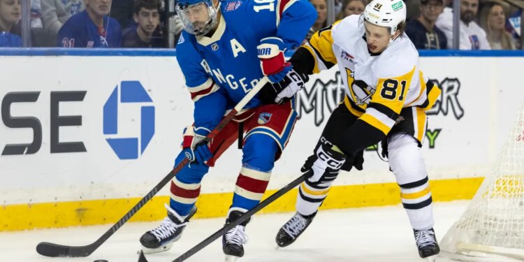 Rangers center Vincent Trocheck (16) is defended by the Penguins' Ben Kindel on Oct. 7, 2025.