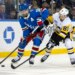 Rangers center Vincent Trocheck (16) is defended by the Penguins' Ben Kindel on Oct. 7, 2025.