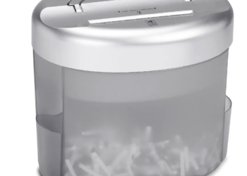 A shredder with some shredded paper visible in the bin.