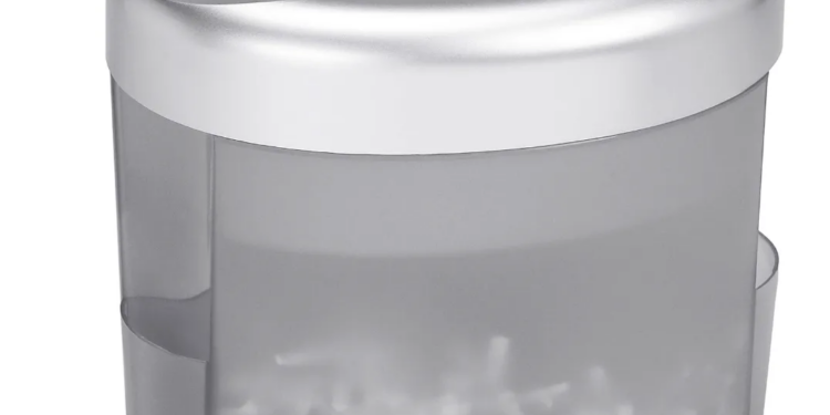 A shredder with some shredded paper visible in the bin.
