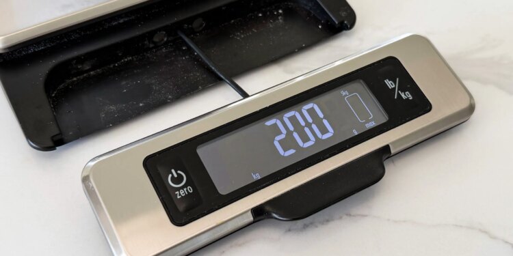 Front of kitchen scale with LED panel pulled out, connected by a single wire.