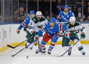 Rangers left wing Will Cuylle passes the puck as Minnesota Wild center Vinnie Hinostroza tries to steal it in the first period at Madison Square Garden in New York, October 20, 2025.