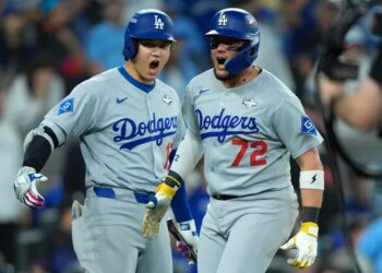 Los Angeles Dodgers second baseman Miguel Rojas (72) and two-way player Shohei Ohtani (17) celebrating after scoring in the ninth inning of game seven of the 2025 MLB World Series.