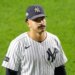Trent Grisham of the New York Yankees looking up while wearing his uniform, cap, and a mustache.