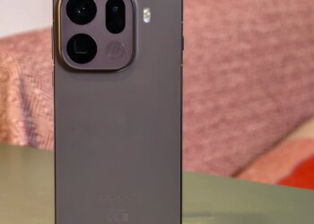 Oppo Find X9 Pro resting on a green table in front of a sofa
