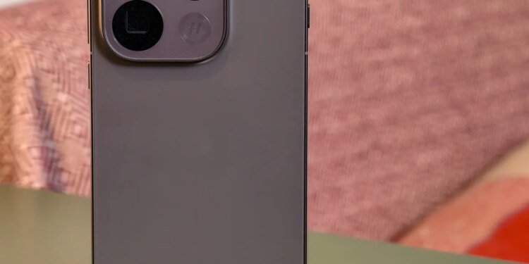 Oppo Find X9 Pro resting on a green table in front of a sofa