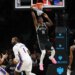 Brooklyn Nets guard Terance Mann (14) hangs on the rim after a missed dunk attempt during the second half of a game against the Philadelphia 76ers at Barclays Center in Brooklyn, N.Y. on Sunday, Nov. 2, 2025.
