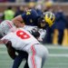 Michigan Wolverines running back Bryson Kuzdzal (24) is tackled by Ohio State Buckeyes linebacker Arvell Reese (8).