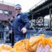 New York Yankees manager Aaron Boone, the 44th precinct and the Food Bank of New York City are distributing food and toys to 500 neighborhood families, Friday, Dec. 19, 2025, in Bronx, NY.