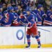 New York Rangers left wing Alexis Lafrenière (13) is greeted by his teammates on the bench after scoring a goal during the second period.