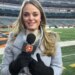 Elise Jesse, a Bengals reporter, holding a microphone in a stadium.