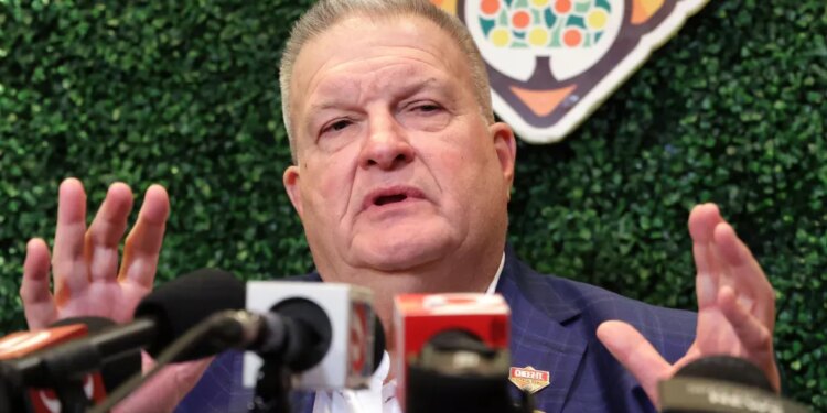 Michigan interim head coach Biff Poggi answers a question during a Citrus Bowl news conference.