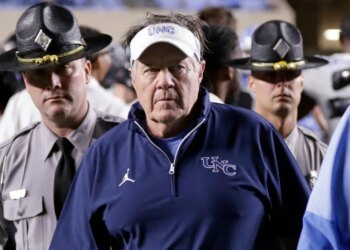 North Carolina head coach Bill Belichick walking off the field after losing a college football game.