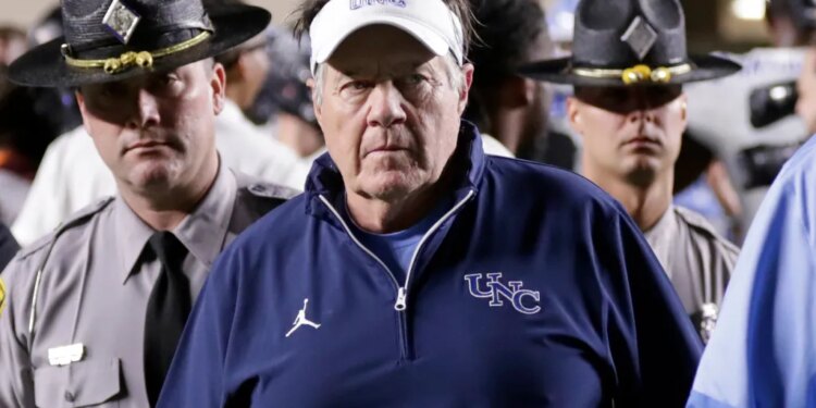 North Carolina head coach Bill Belichick walking off the field after losing a college football game.