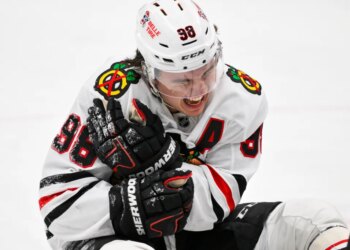 Chicago Blackhawks center Connor Bedard (98) reacts in pain after a face off against St. Louis Blues center Brayden Schenn during the third period.