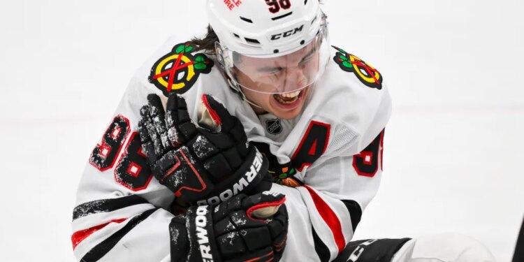 Chicago Blackhawks center Connor Bedard (98) reacts in pain after a face off against St. Louis Blues center Brayden Schenn during the third period.