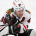 Chicago Blackhawks center Connor Bedard (98) reacts in pain after a face off against St. Louis Blues center Brayden Schenn during the third period.
