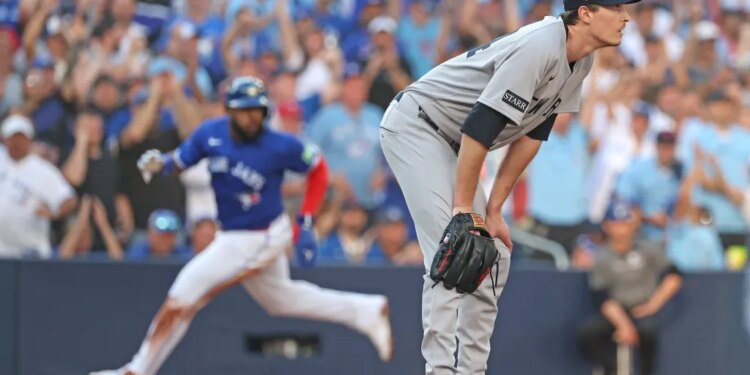 Yankees pitcher Max Fried (54) reacts as the Blue Jays' Vladimir Guerrero Jr. (27) scores on a Daulton Varsho double in Game 2 of the ALDS on Oct. 5, 2025.
