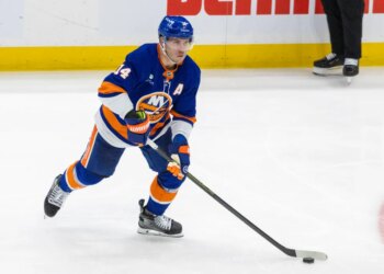 Bo Horvat of the New York Islanders moving the puck down the ice.