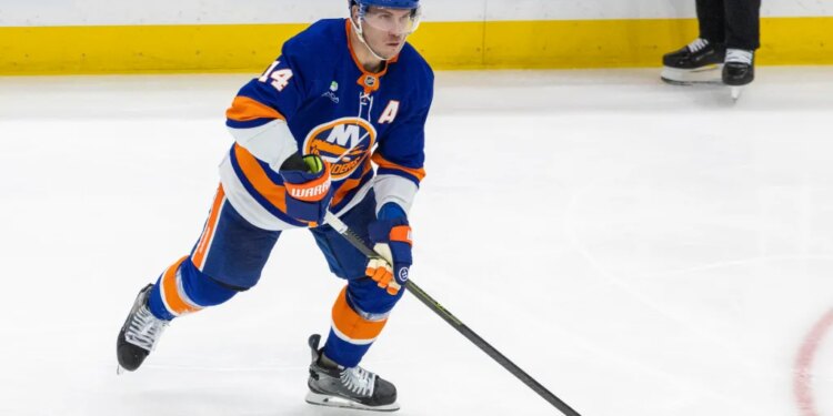 Bo Horvat of the New York Islanders moving the puck down the ice.