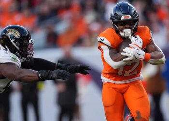 Jacksonville Jaguars and Denver Broncos players during a football game.