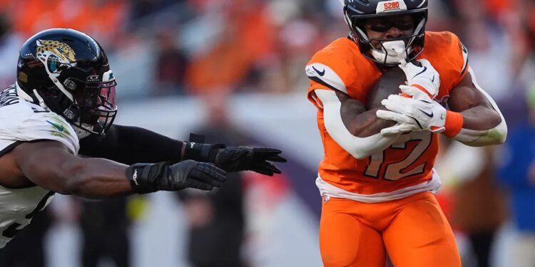 Jacksonville Jaguars and Denver Broncos players during a football game.