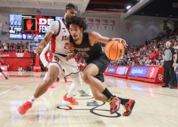 Harvard Crimson forward Thomas Batties II (15) looks to drive past St. John's Red Storm forward Bryce Hopkins (23) in the first half at Carnesecca Arena.