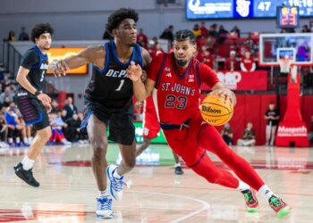 Bryce Hopkins #23 of the St. John's Red Storm drives to the basket as Kaleb Banks #1 of the DePaul Blue Demons gives chase.Bryce Hopkins #23 of the St. John's Red Storm drives to the basket as Kaleb Banks #1 of the DePaul Blue Demons gives chase