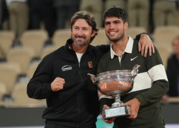 Carlos Alcaraz poses with his coach Juan Carlos Ferrero after winning the final match of the French Tennis Open against Italy's Jannik Sinner at the Roland-Garros stadium in Paris, Sunday, June 8, 2025.