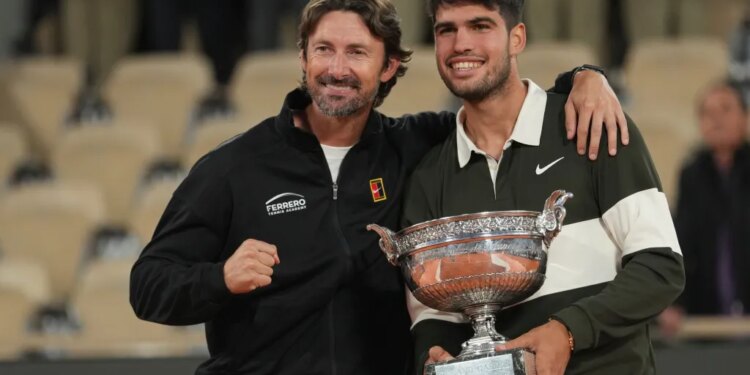 Carlos Alcaraz poses with his coach Juan Carlos Ferrero after winning the final match of the French Tennis Open against Italy's Jannik Sinner at the Roland-Garros stadium in Paris, Sunday, June 8, 2025.